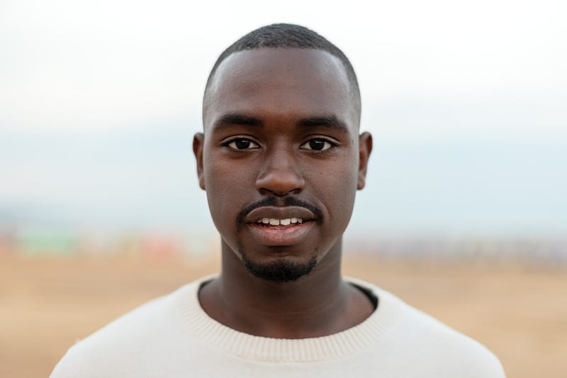Portrait of young African American man looking at camera. Headshot.